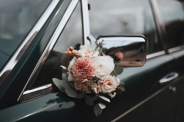 Floral bouquet attached to a wedding car